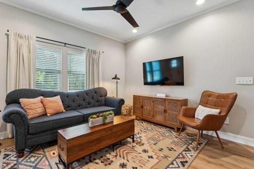 a living room with a couch and a tv at Loft Haven - Rooftop Terrace in Charlotte