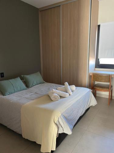 a bedroom with a bed with towels on it at Terruar Wine in Ciudad Lujan de Cuyo
