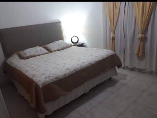 a bedroom with a bed in a room at Casa de vacaciones Naty in Villa Carlos Paz