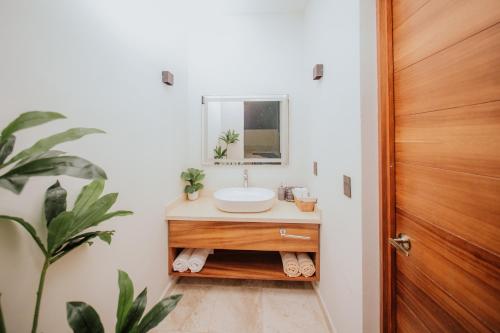 a bathroom with a sink and a mirror at Villa Marena Hotel Boutique in Coyuca
