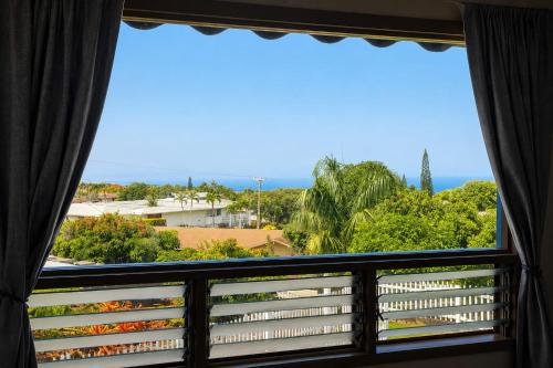 a window with a view of the ocean at Quiet 2BR Kona Retreat Beach Gear BBQ Patio in Kailua-Kona