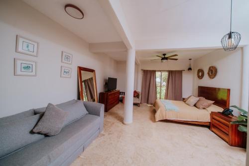 a living room with a couch and a bed at Villa Marena Hotel Boutique in Coyuca