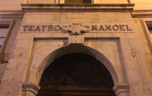 an entrance to a building with a sign over a door at The Manoel Boutique Hotel in Valletta