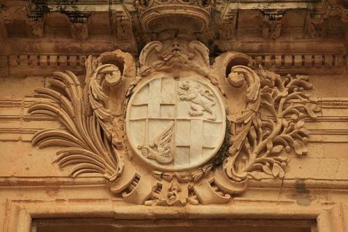 a clock on the side of a building at The Manoel Boutique Hotel in Valletta