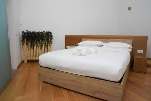 a bedroom with a large bed with white sheets and pillows at Milan Luxury Loft with Sauna & Jacuzzi in Milan