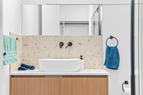 a bathroom with a sink and a blue towel at Sleek Contemporary Haven Geelong in Highton