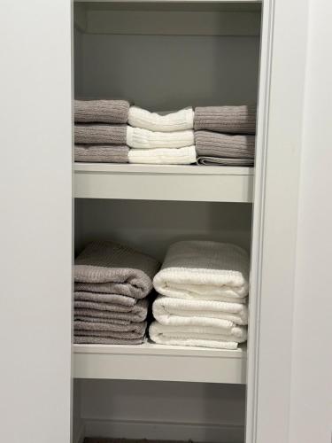 a closet with a bunch of towels in it at Papillon Home in Rockbank