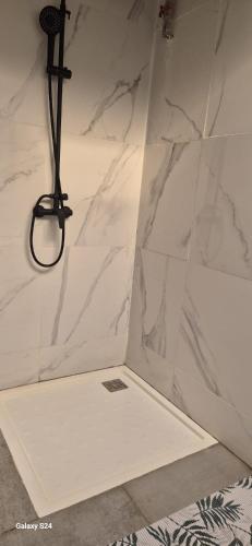 a bathroom with a white marble shower stall with a light at Villa Miradie in Grand-Bassam
