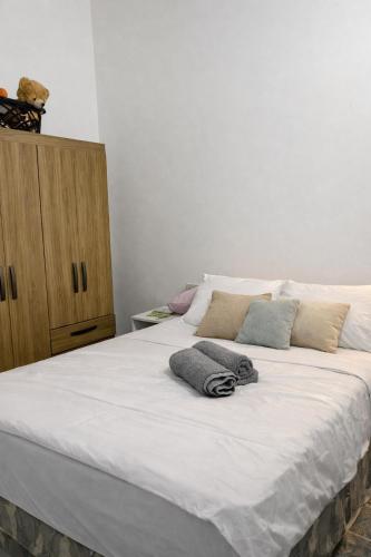 a large white bed with two pillows on it at Casa completa Ecovia Ruta Luque San Bernardino in Zarate Isla