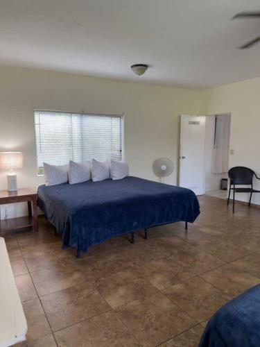 a bedroom with a bed with a blue bedspread at Hawaii Island Resort in Naalehu