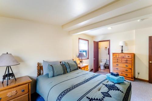 a bedroom with a bed and a dresser and a bathroom at Ski Bowl Cottage! in Hunter