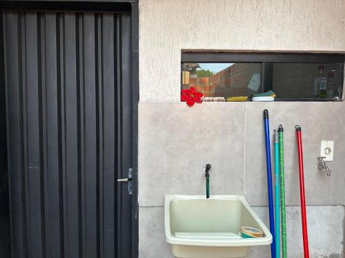 a bathroom with a sink and some baseball bats at Casa completa Ecovia Ruta Luque San Bernardino in Zarate Isla