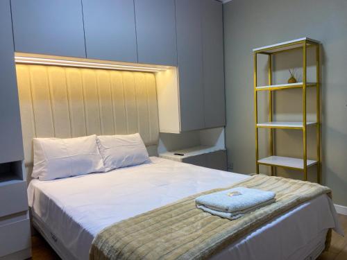 a bedroom with a bed with a towel on it at Refugio Nordico de 3 habitaciones inc Cochera en 2do piso in Trujillo