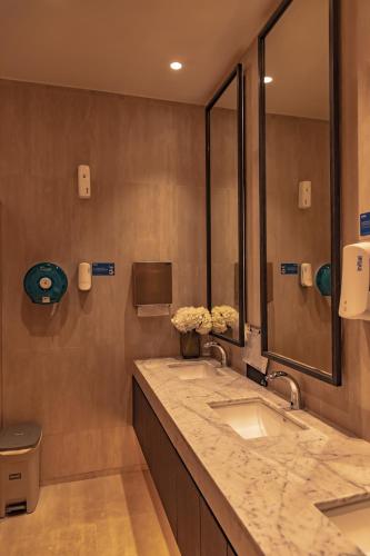 a bathroom with two sinks and a large mirror at Title Legendary Studio with Balcony by TVC C407 in Bang Tao Beach