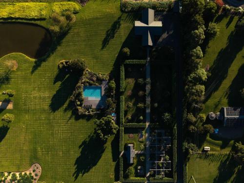 an overhead view of a park with a house and a pond at Linnaeus Farm, Berry - by Linnaeus Collection in Berry