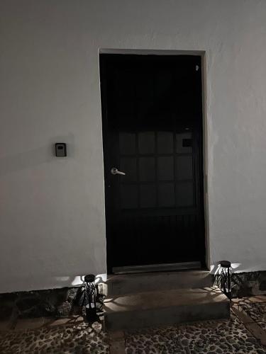a black door in a white walled room at Ribera del Lago in Jocotepec