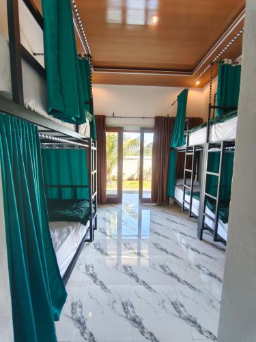 a room with bunk beds and a corridor at Snooze hostel lombok in Selong Belanak