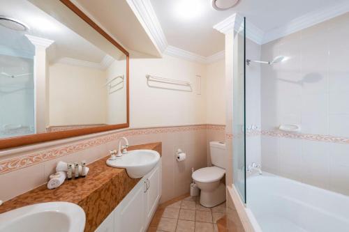 a bathroom with a sink and a toilet and a shower at Breakers 1-3 - Ocean Views - Stone Real Estate Yamba in Yamba