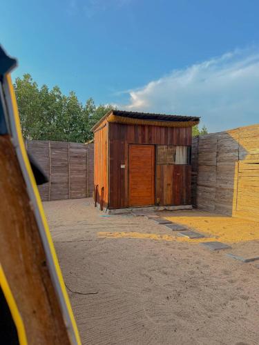 a small wooden building with a wooden door at Coody Seastar in Ban U Taphao