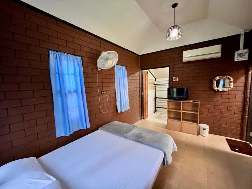 a bedroom with two beds and a blue window at บ้านสวนบรรจงอักษร Bansuan Banjong Akkson in Rayong
