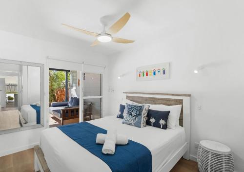 a bedroom with a bed and a ceiling fan at Pippi Sands - Pet Friendly - Stone Real Estate in Yamba
