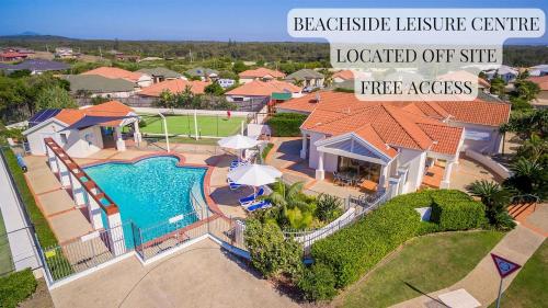 an aerial view of a house with a swimming pool at Six River - Town Location - Stone Real Estate Yamba in Yamba