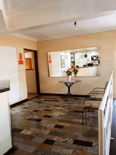 a living room with a table and a table sidx sidx sidx at Hotel center Ribeirão in Ribeirão Preto