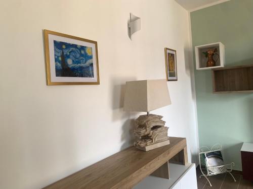 a room with a table with a lamp on it at Casa vacanza Gea - Superior Apartment in Bergamo city with private parking car in Bergamo