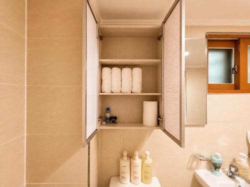 a bathroom with a sink and a mirror at Stay U in Suwon