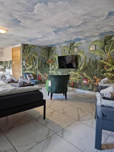 a bedroom with a wall mural of plants at Apartamenty Traugutta 47 in Radom
