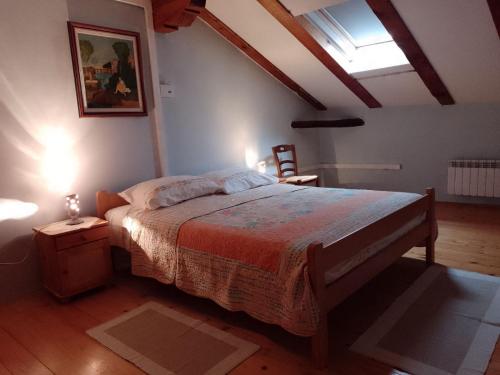 a bedroom with a large bed in a attic at Apartments Lazzarini Battiala in Nedeščina