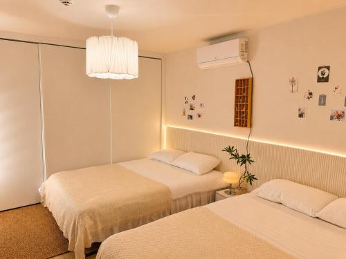 a hotel room with two beds and a chandelier at Stay U in Suwon