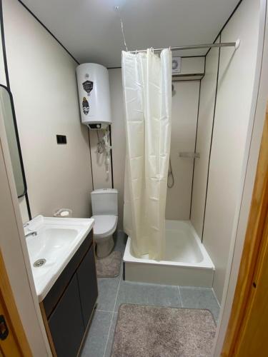 a small bathroom with a shower and a toilet at Sarala Resort in Ostrov Kayrak