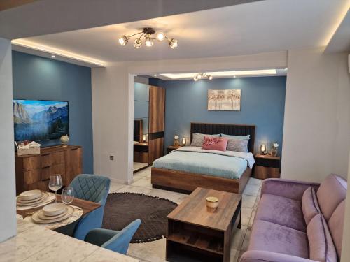 a bedroom with a bed and a living room at Miradi Art Apartment in Stara Zagora