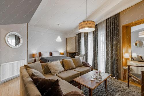 a living room with a couch and a table at Hotel Beli in Tbilisi City