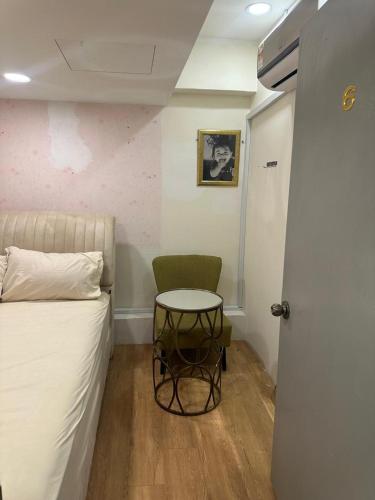 a room with a bed and a table and a door at Guest Room Star Avenue in Shah Alam