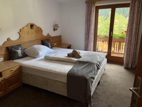 a bedroom with a bed with a teddy bear on it at Haus Traudl in Filzmoos