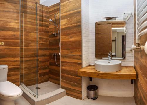 a bathroom with a sink and a shower at Hotel Beli in Tbilisi City