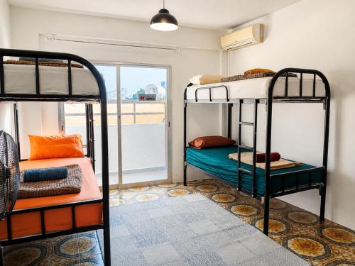 a room with two bunk beds and a window at Swift Hostel Limassol in Limassol