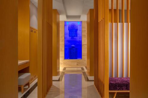 a hallway with a blue window and two benches at Hyatt Regency Riyadh Olaya in Riyadh