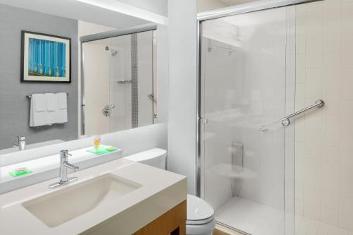 a white bathroom with a sink and a shower at Hyatt Place Athens Downtown in Athens