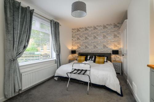 a bedroom with a bed and a window at Sandyhill, St. Andrews in Fife