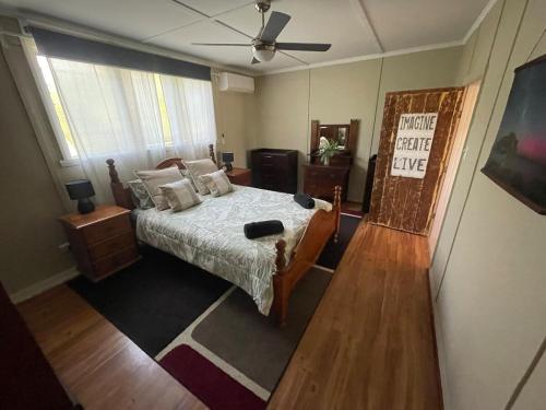 a bedroom with a bed and a ceiling fan at Jack's Tidal Pool Shack in Kingscote