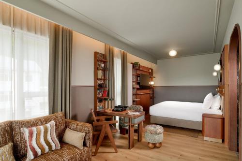 a hotel room with a bed and a couch at Skald Hotel Akureyri, Curio Collection By Hilton in Akureyri