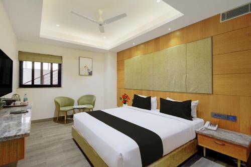 a hotel room with a bed and a television at Palette Mahbubabad Railway Station Formerly Hotel RC Platinum in Mahbūbābād