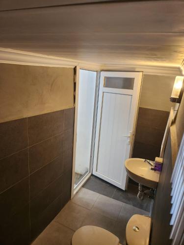 a bathroom with a toilet and a sink at Çeşme MASAL in Çeşme