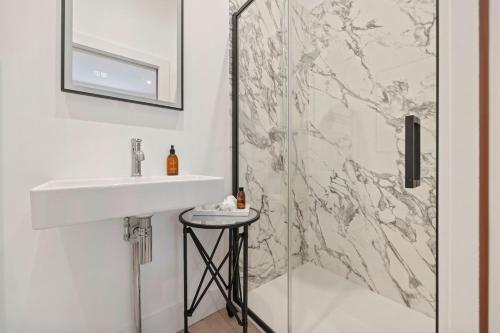 a bathroom with a sink and a shower at Grange Cottage in Galashiels