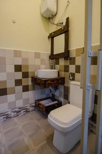 a bathroom with a toilet and a sink at pumzika hill in Arusha