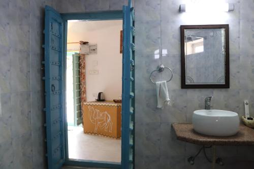 a bathroom with a sink and a mirror at Desert Nights in Mandāwa