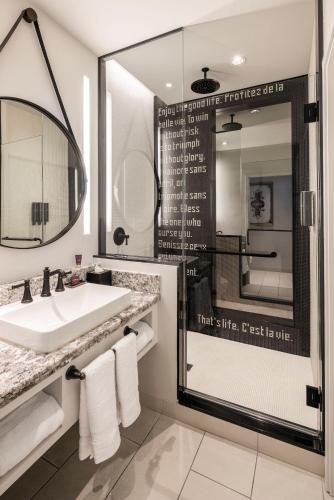 a bathroom with a sink and a mirror at The Vanderpump Las Vegas Hotel & Casino - A Caesars Rewards Destination in Las Vegas